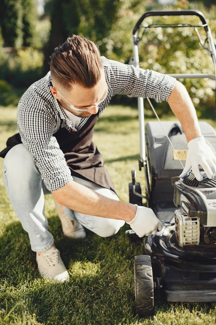 menu-01 Man in a garden repairing lawn mower on sunny day, ideal for gardening and maintenance themes.